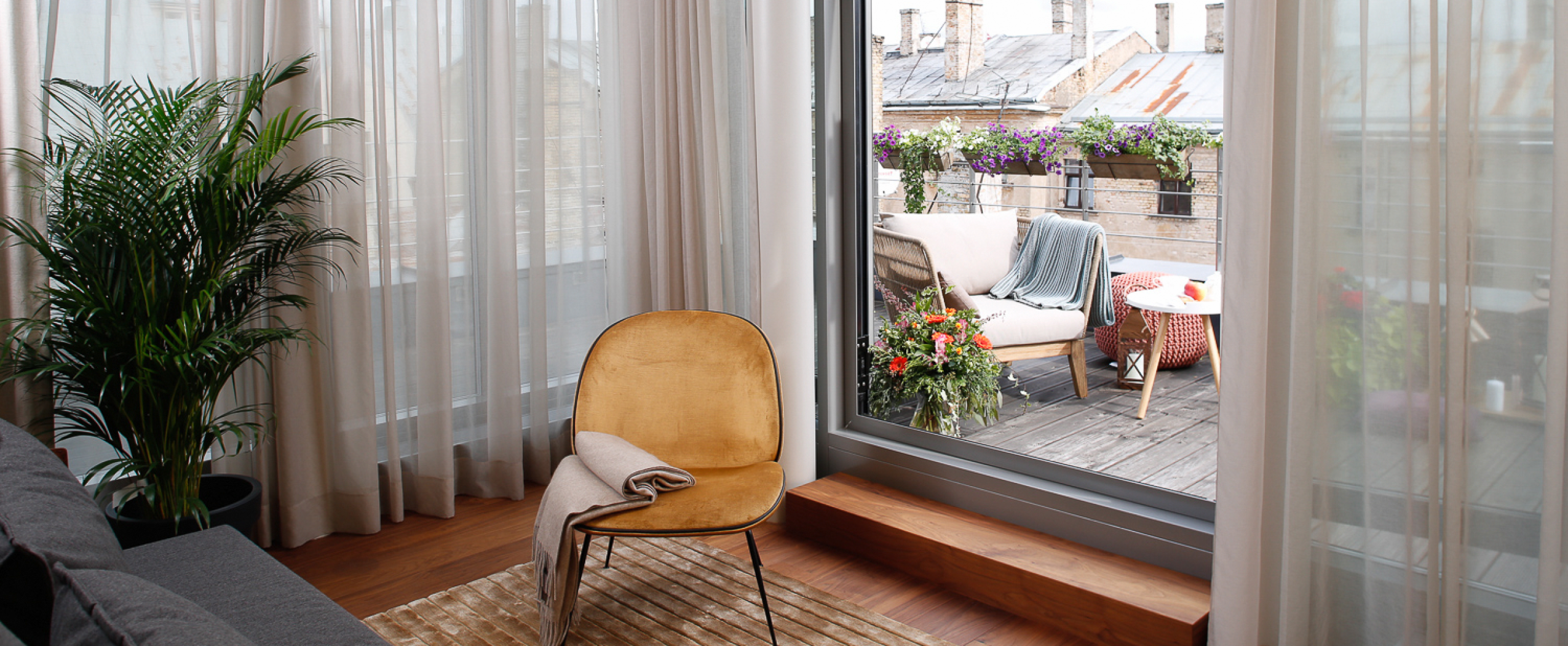 A cozy, beautifully designed terrace of the CENTRUS building with a panoramic view over the rooftops of Riga’s city center.
