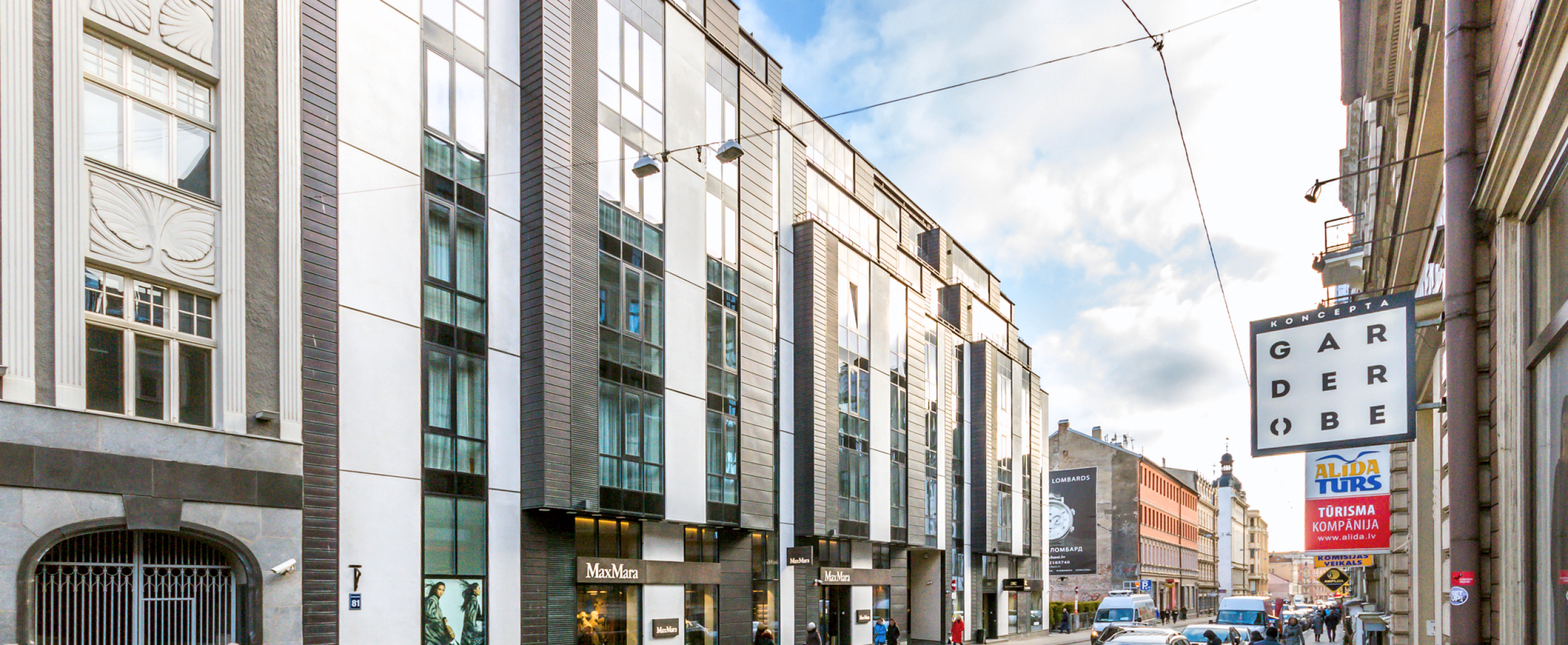 CENTRUS first-stage building on Dzirnavu Street with ground-floor shops and modern architecture in central Riga.